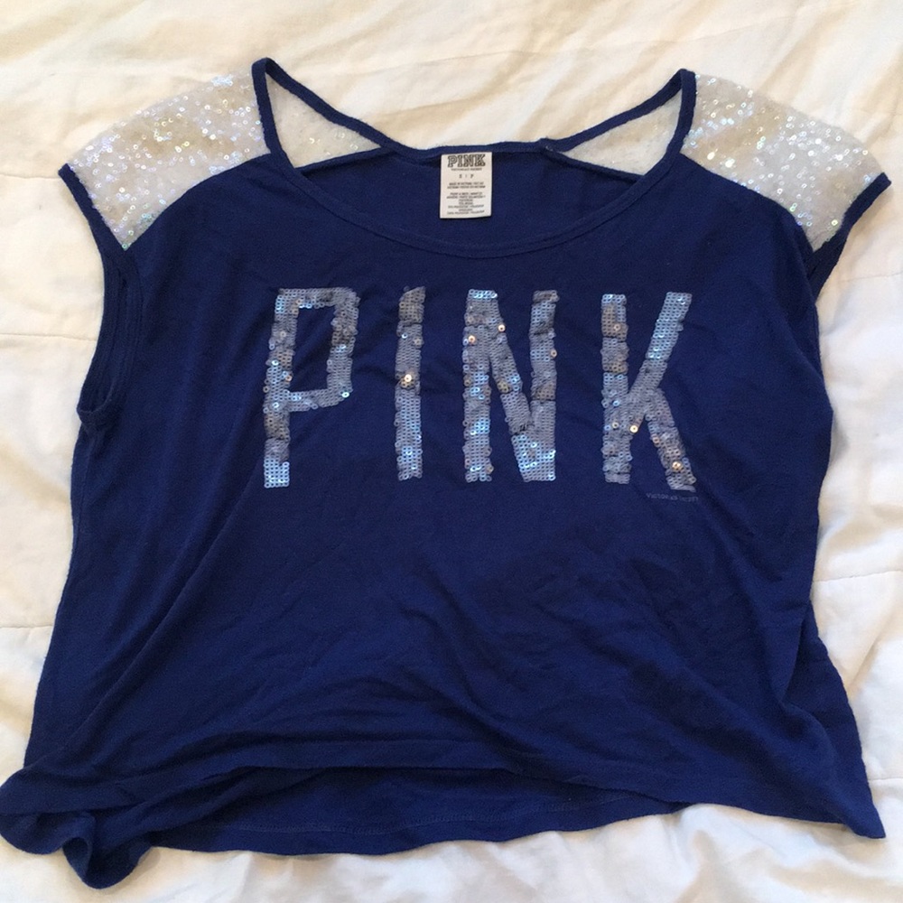 Blue shirt with “Pink” in white sequence. Size S.